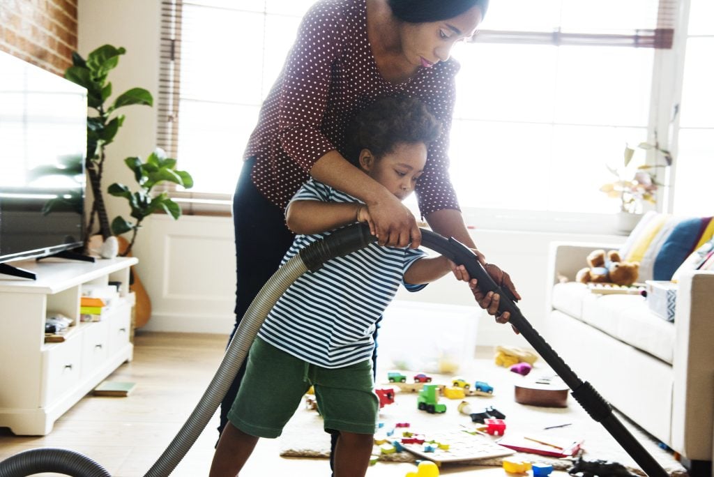 Spring Cleaning Tips for Energy Savings - Son helping his mother clean the room