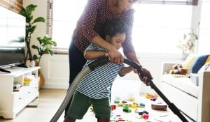 Spring Cleaning Tips for Energy Savings - Son helping his mother clean the room