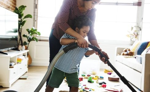 Spring Cleaning Tips for Energy Savings - Son helping his mother clean the room